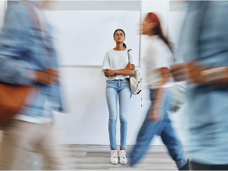 5 Tips for Mid-Semester Stress Blurred foot traffic in a school hallway.